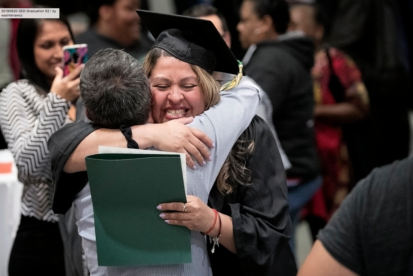 Karol Oviedo-Perez hugs her father after the WCC Adult Transitions Pathways Student Recognition Ceremony. Oviedo-Perez had not seen her father in 14 years, until days before the ceremony when he arrived from Costa Rica. (Photo by Kelly Gampel)