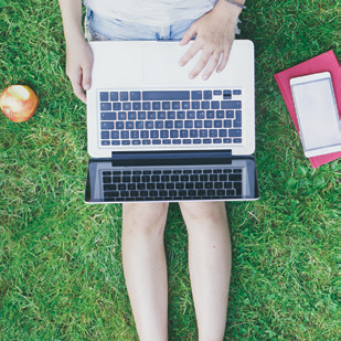 Student on laptop outside