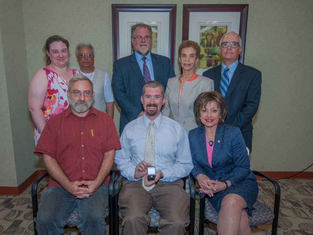 WCC Student Development and Activities Director Pete Leshkevich displays his pin of appreciation alongside WCC Board of Trustees (top left) Secretary Christina Fleming, Ruth A. Hatcher, Chair Richard J. Landau, J.D., Ph.D., Vice Chair Diana McKnight-Morton, Treasurer Stephen J. Gill, Ph.D., David DeVarti, and WCC President Dr. Rose B. Bellanca. (Photo by Jessica Bibbee)