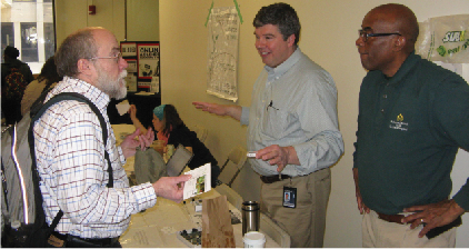 Computer Information Systems faculty member (L to R) Phil Geyer learns from Energy and Systems Integration Manager Bill Ghrist and Recycling Operations Manager Barry Wilkins, about how remote monitoring of lighting, temperature and humidity are being used to reduce energy consumption on campus.