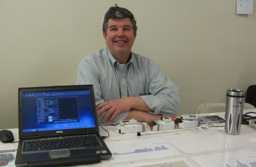 Energy and Systems Integration Manager Bill Ghrist demonstrates how new remote devices and software that monitors lighting, temperature and humidity are being used to reduce energy consumption on campus.