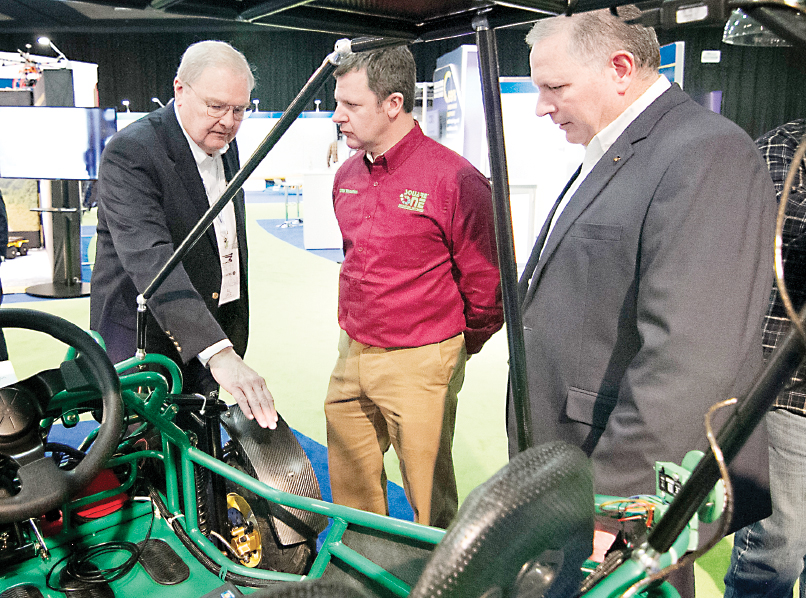 Al Lecz (left), Director of the WCC Advanced Transportation Center, describes a prototype vehicle exhibited at this year’s North American International Auto Show. Constructed and assembled with lightweighting materials by WCC faculty and students using the college’s state-of-the-art equipment, the vehicle features examples of transmitters, receivers and sensors needed to communicate autonomously with other connected vehicles and infrastructure. (Photo by Kelly Gampel)