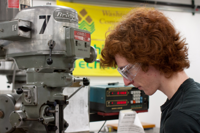 student working on machinery